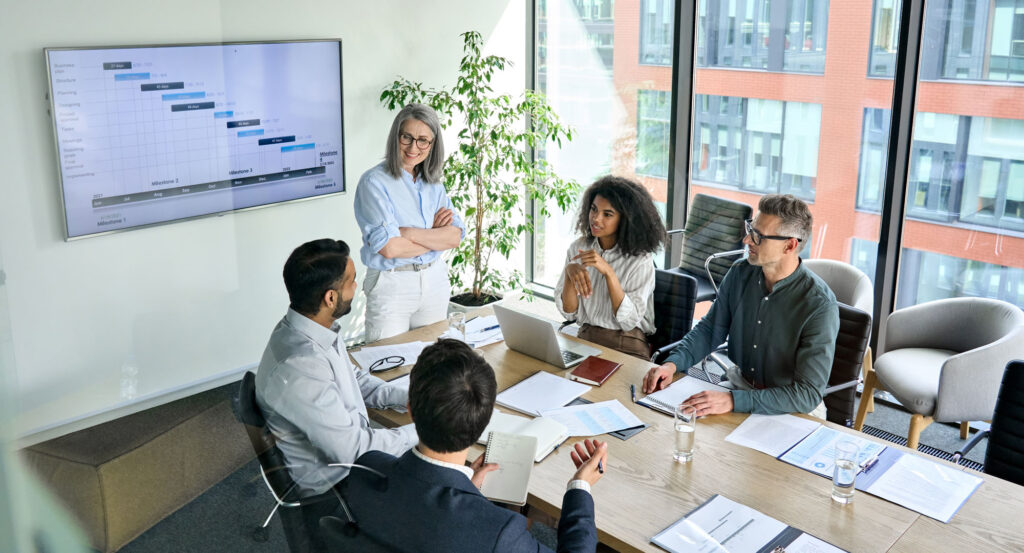 Curious leadership in action during a team meeting, with a leader actively listening to build trust and improve communication under stress
